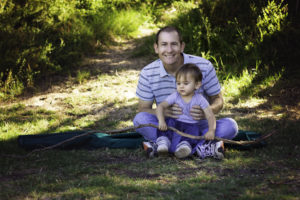 Father and child with stick